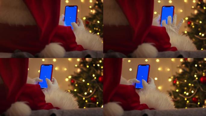 圣诞老人用蓝色色度键在智能手机上打字
