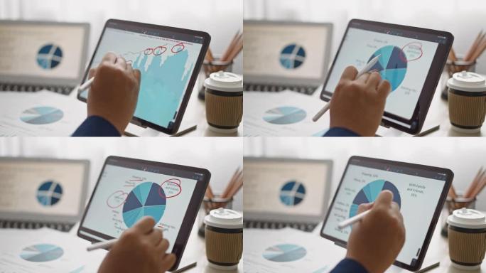 特写手牌商人分析数字平板电脑上的商业数据