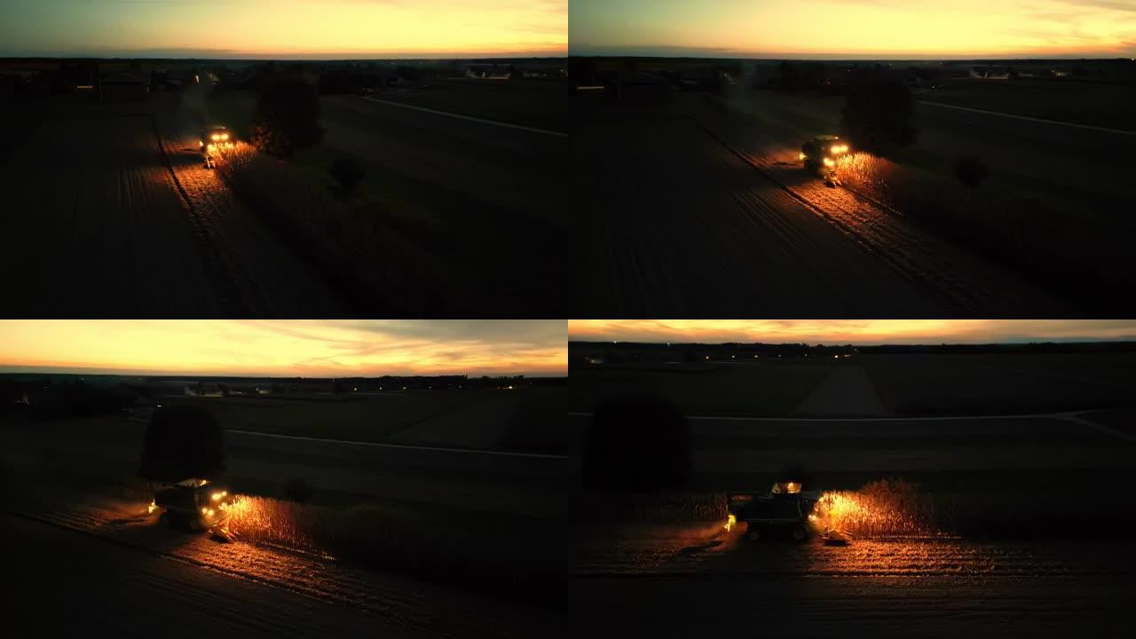 夜间，联合收割机在田野中央收割玉米