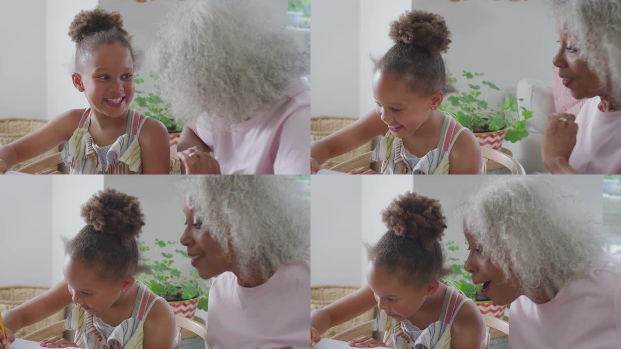 祖母在餐桌旁帮助孙女在家上学