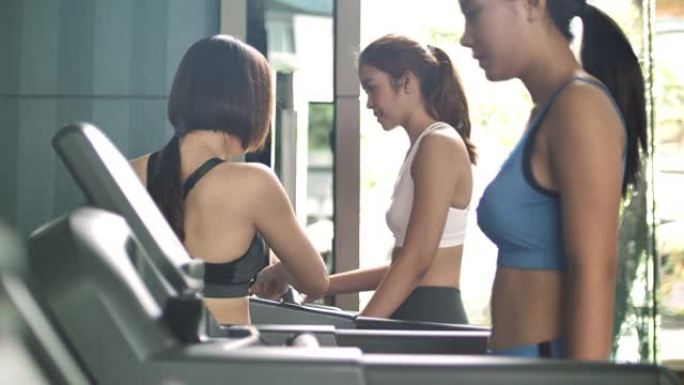 年轻女子与私人教练一起在健身房锻炼