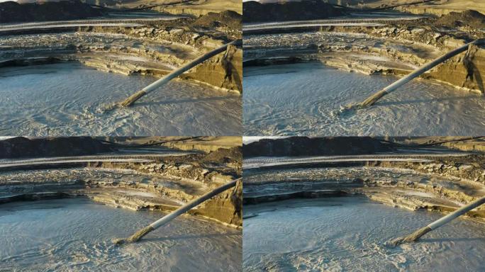 从空中平移到矿井尾矿坝中的环境危险有毒水的视图