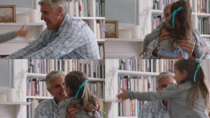 可爱的小女孩抱着祖父调皮地跳到爷爷的怀里和祖父母在家享受周末的乐趣