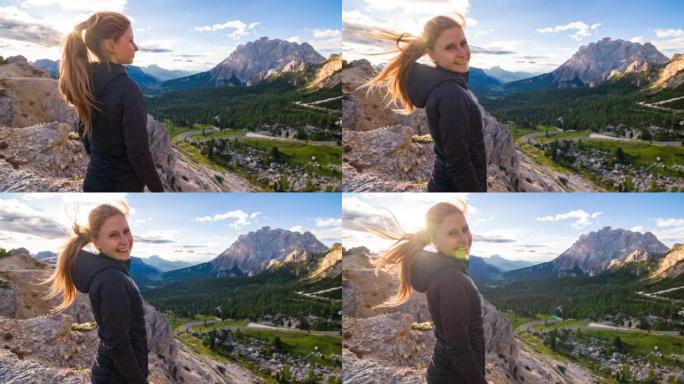 女人从山顶欣赏壮丽的景色，俯瞰雄伟的山谷