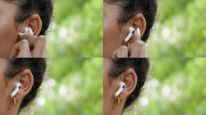 耳朵，耳塞和女人在bokeh模型背景上听音乐，音频或播客。流媒体，耳机或耳机女孩在大自然中追赶她最喜
