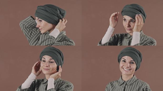 漂亮的穆斯林妇女固定头巾并在镜头前微笑