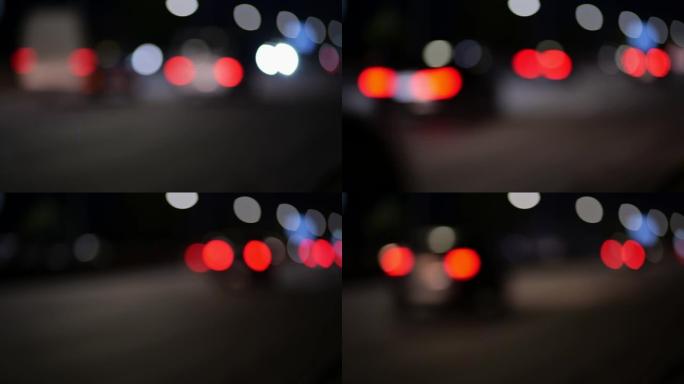 城市街道上模糊的城市交通。散焦的夜间交通信号灯。汽车在夜城的街道上匆匆忙忙