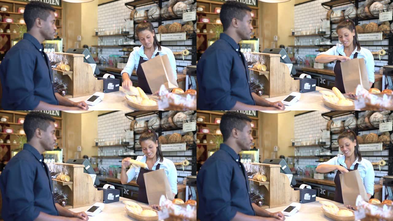 面包店服务员向一个男人卖面包