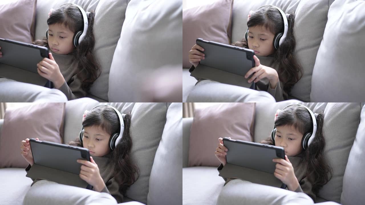女孩在家用数字平板电脑在线学习