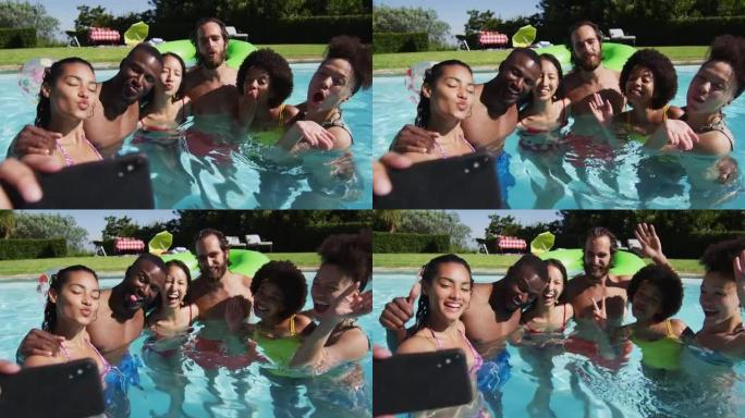 多样化的朋友在游泳池里自拍照