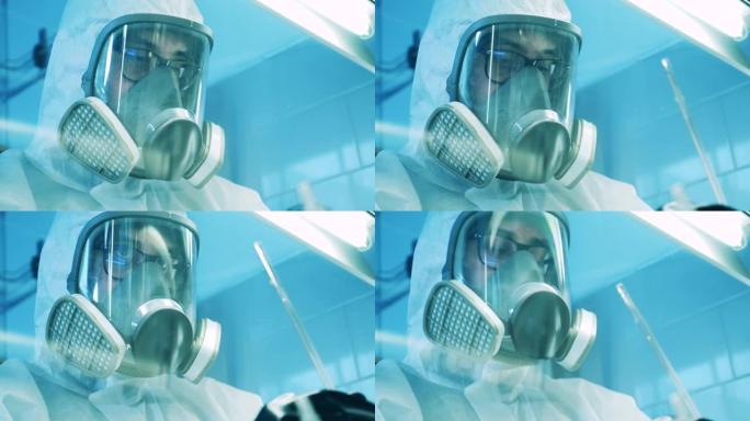 实验室专家穿着防护服透过橱柜玻璃拍摄