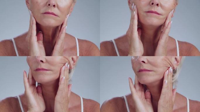 护肤品，皱纹和高级女性在工作室触摸她的脸，以防止皮肤老化。美容，自我护理和老年女性模特在灰色背景下进