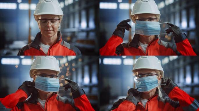 一位专业的重工业工程师/工人在钢铁厂戴上安全面罩的肖像。站在金属建筑设施中戴着安全帽的美丽女性工业专