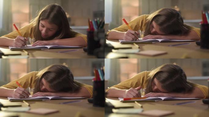 一个年轻女孩独自坐在家里做作业时睡着的4k视频片段