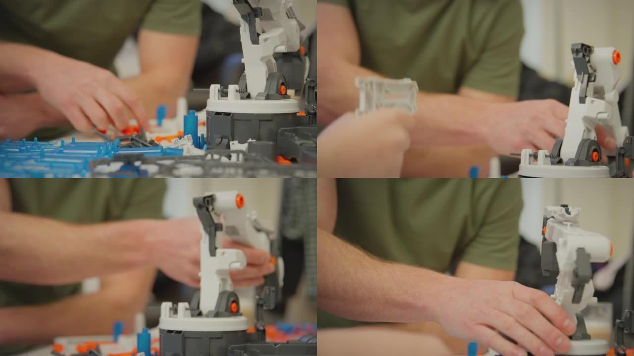 穿着睡衣的父亲和儿子在科学项目的家中用塑料套件建造机械臂的特写镜头-慢动作拍摄