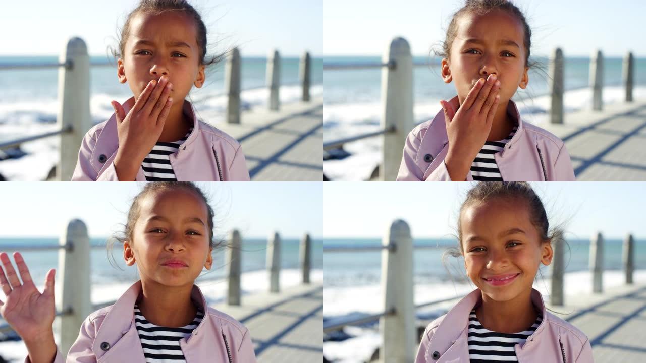 暑假期间，孩子，童年和肖像在海滨长廊上吹吻。小女孩，在南非海角度假或度假时亲吻和娱乐