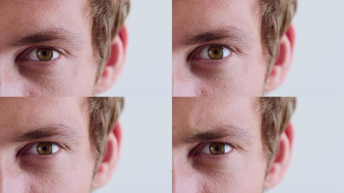 男人，脸和棕色眼睛在医疗保健，人文意识或记忆创伤的工作室背景。在压力，恐惧或担忧中，医疗护理人员的缩