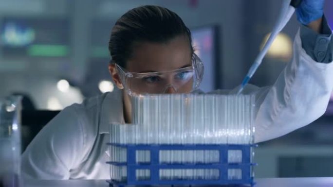 一名年轻女子在实验室使用滴管和试管的4k录像