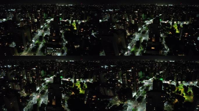 阿根廷布宜诺斯艾利斯夜间照明城市上方的无人机视图。4k分辨率。