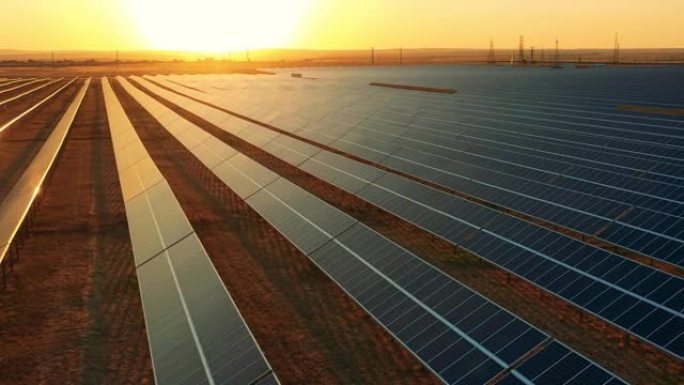 在明亮的日落时分拍摄太阳能农场的无人机