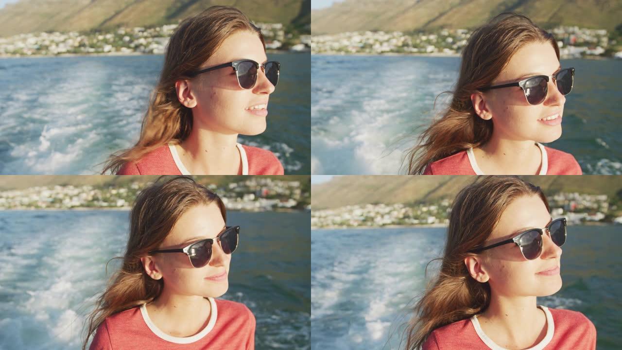 一个十几岁的高加索女孩在船上享受时光的侧视图