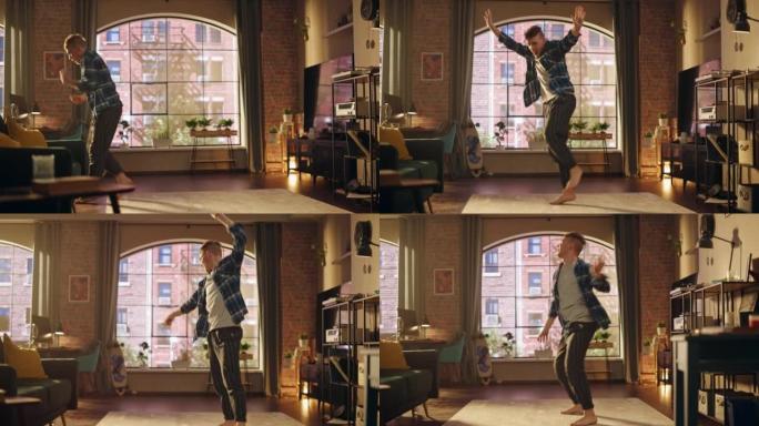 英俊的年轻男性穿着舒适的家装跳舞，在阁楼公寓为自己举办派对。为社交媒体录制有趣的病毒视频。
