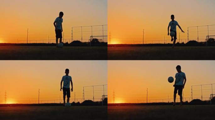 慢动作男孩在黄昏时在野外玩足球