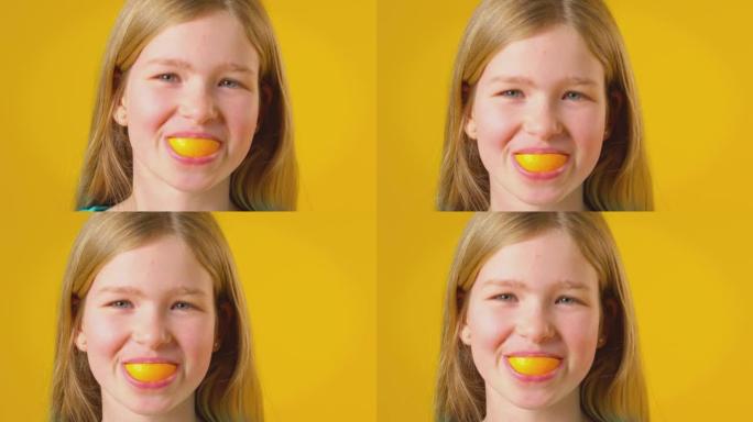 在黄色演播室背景下，女孩使用橙色片段进行口腔和牙齿拍摄 -- 慢动作拍摄