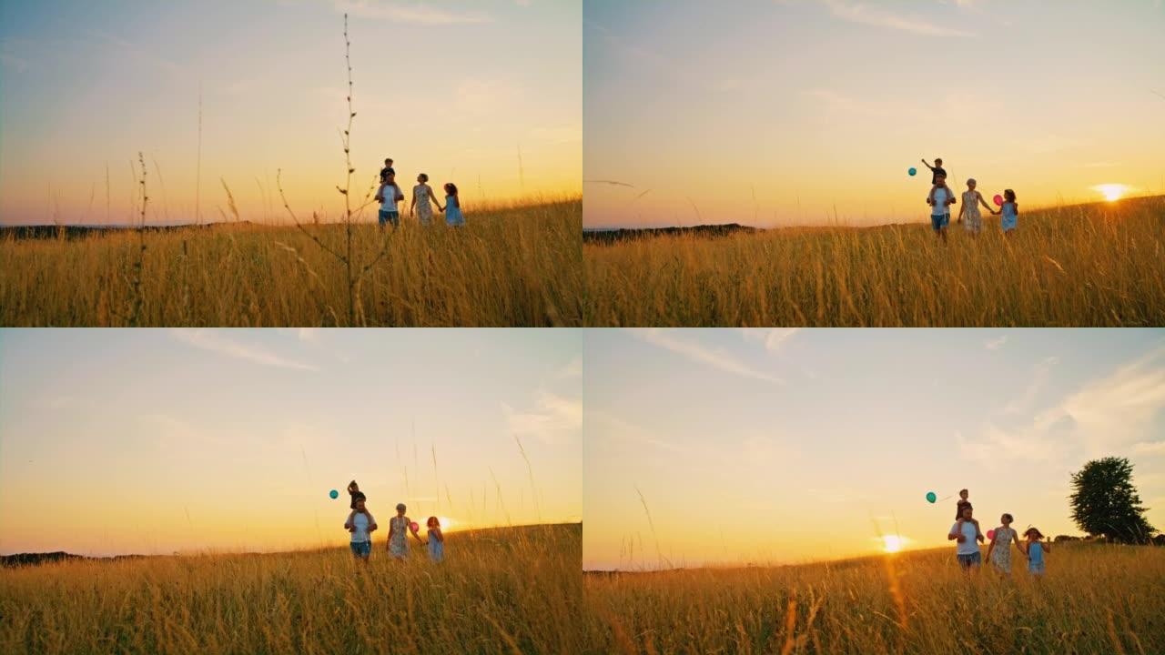 日落时，SLO MO一家带着两个孩子在草地中央散步