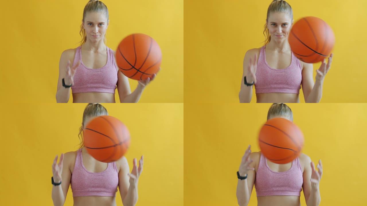 年轻女子打篮球并看着相机的肖像