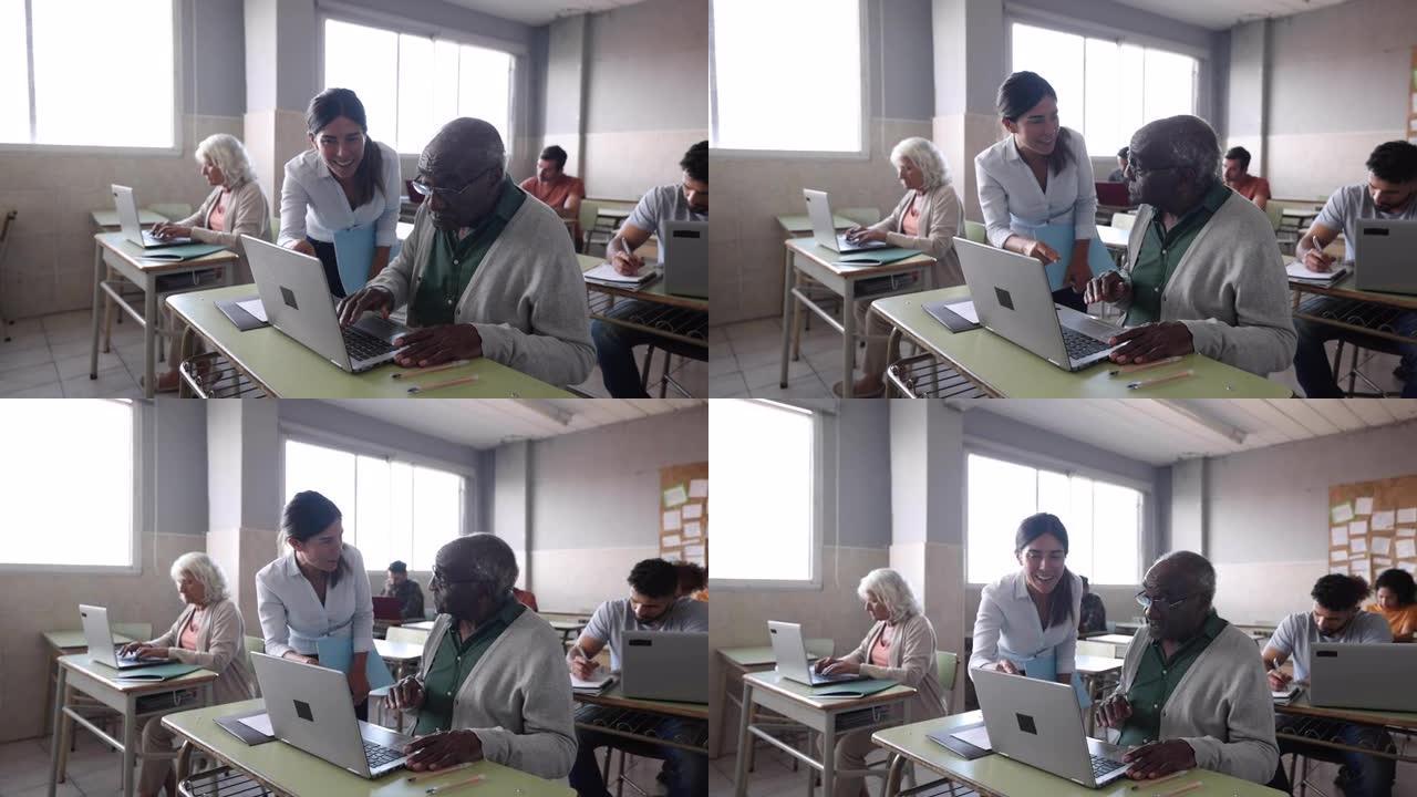 有爱心的老师在使用笔记本电脑时在IT课上帮助一名黑人高级患者