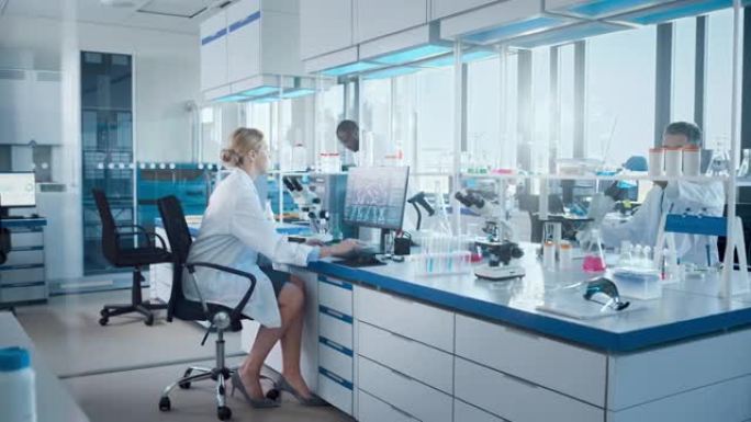 医学实验室与不同的生物化学科学家团队开发药物，女性微生物学家在计算机上工作，显示器显示基因编辑界面。