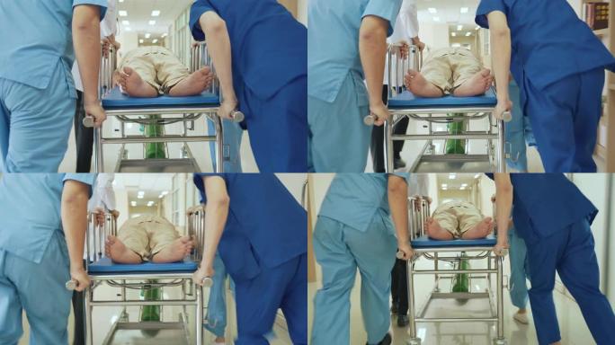 医务人员将医院走廊中的紧急患者转移到急诊室的后视图
