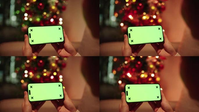 在圣诞树背景上使用手机绿屏