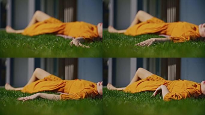 SLO MO年轻女子躺在草坪上时碰到绿草