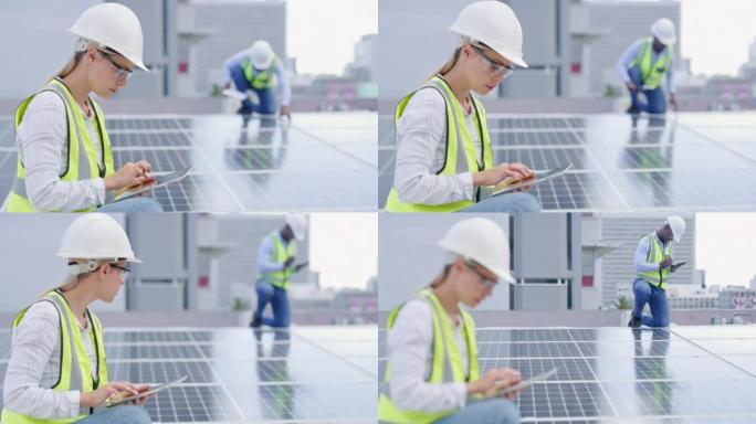 一位认真的年轻女子在建筑物的屋顶上安装太阳能电池板时使用数字平板电脑。一位专注于在线从事可再生能源建