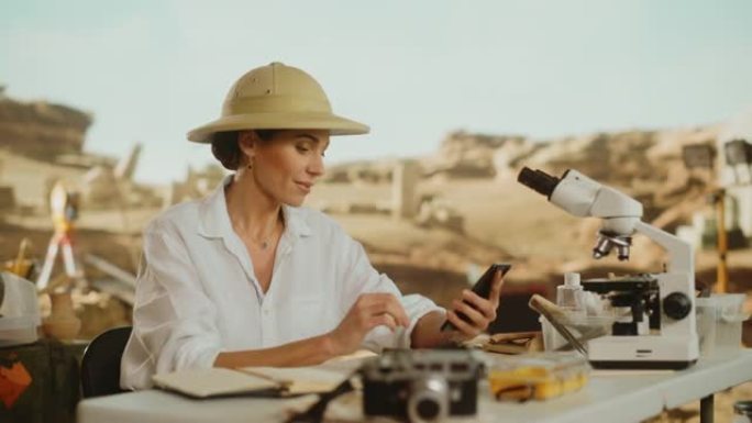 考古挖掘地点: 伟大的女性考古学家进行研究，使用智能手机扫描和分析化石遗迹，古代文明文化文物。历史学