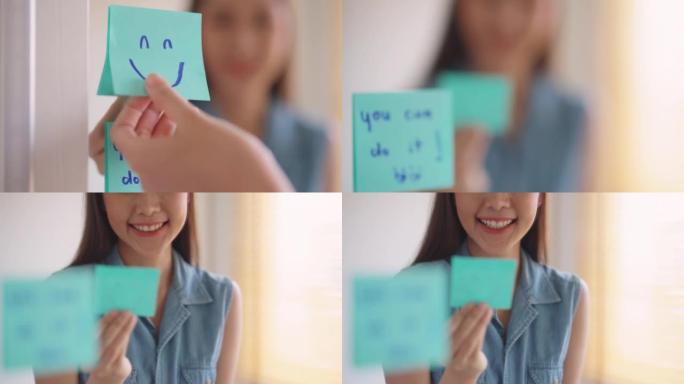 亚洲女性在镜子前用微笑便利贴自言自语。