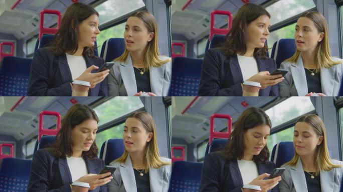 两名带外卖咖啡的女商人上下班在火车上一起看手机