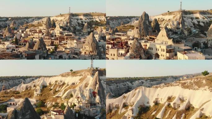 夏季卡帕多西亚土耳其，无人驾驶飞机在美丽的阳光明媚的小古镇上空飞行，位于历史悠久的白色大石头之间。