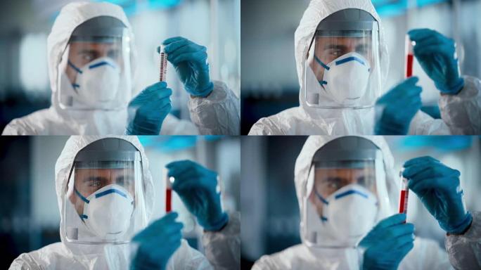 医学研究科学家穿着工作服，手术手套，面罩和盾牌将试管与血液样本和标签读取新型冠状病毒肺炎保持在一起。
