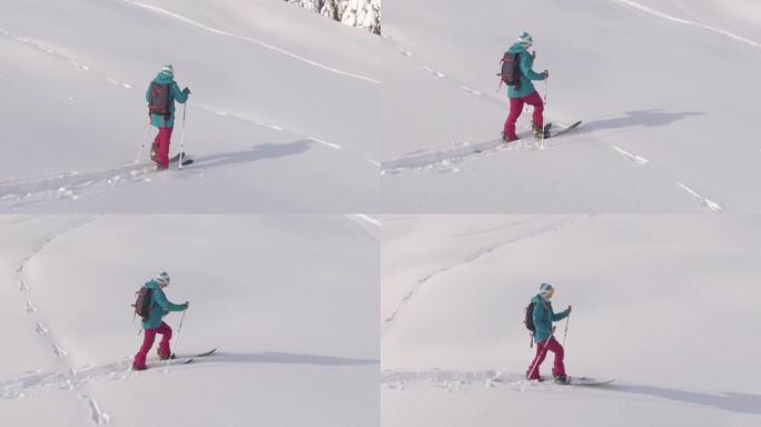 空中: 年轻女子在乡村徒步旅行，在朱利安阿尔卑斯山的滑雪道上分裂