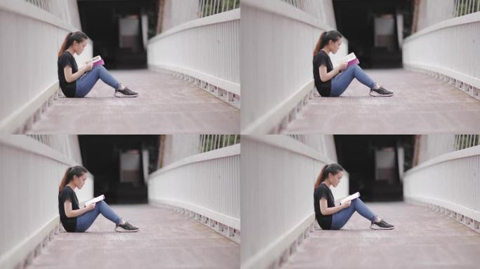 十几岁的女孩在桥上读书