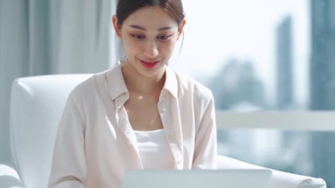 使用技术笔记本电脑开始工作的亚洲女商人的特写肖像