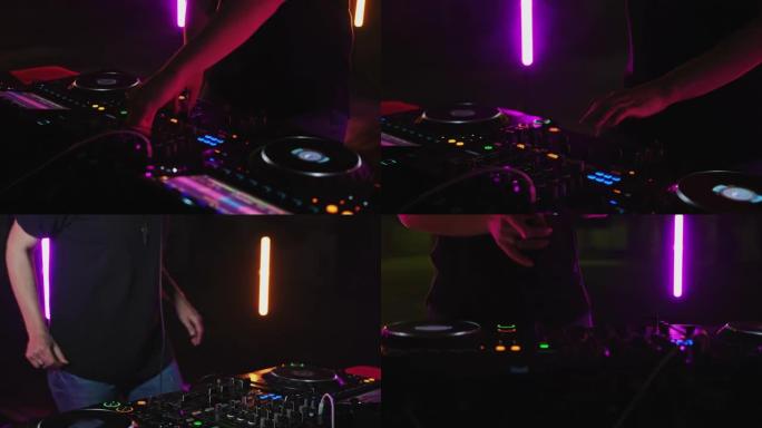 DJ在霓虹灯下在混音器上播放音乐混音