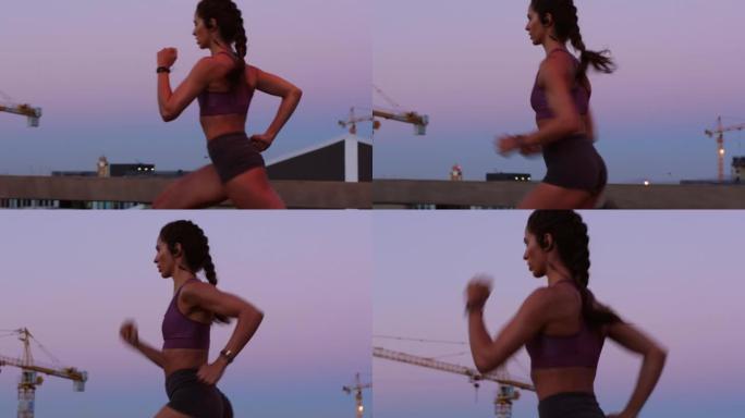 能量，速度和健身训练由运动员在日落时跑步，认真并关注健康目标。年轻女子进行激烈的有氧运动，练习耐力和