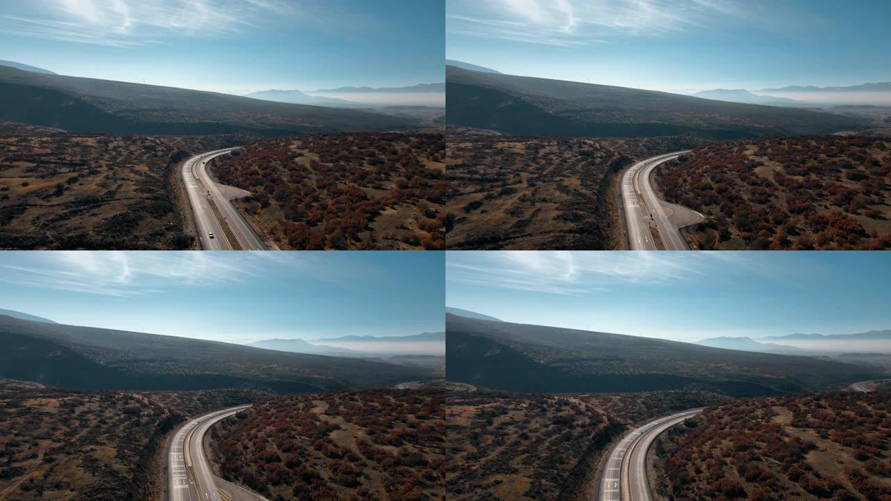 山路蜿蜒，蓝天映衬。运输的概念。无人机录像。