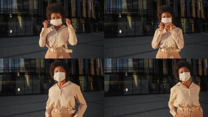 一位年轻漂亮的黑皮肤妇女戴着防护口罩站在商务中心