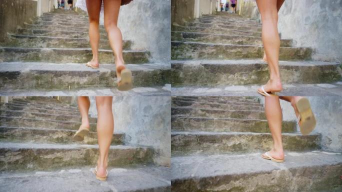一个女人在度假时爬上一组台阶时的腿特写