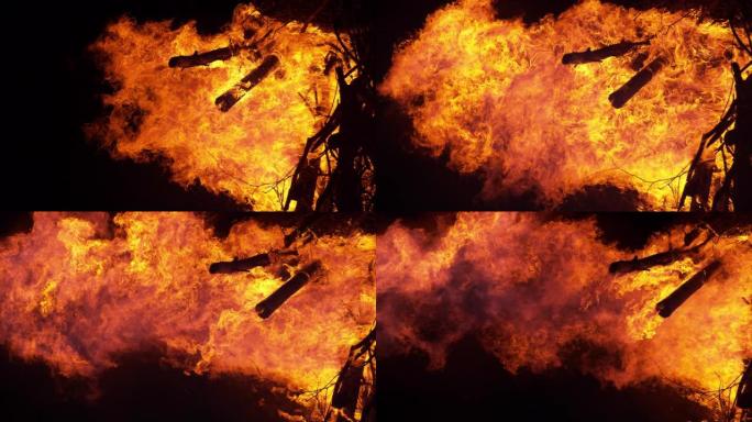 垂直，特写: 炽热的炽热火焰吞噬了一大堆柴火。